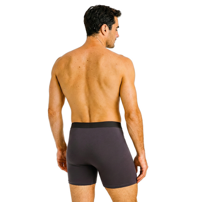 Man wearing dark gray boxer briefs on a white background